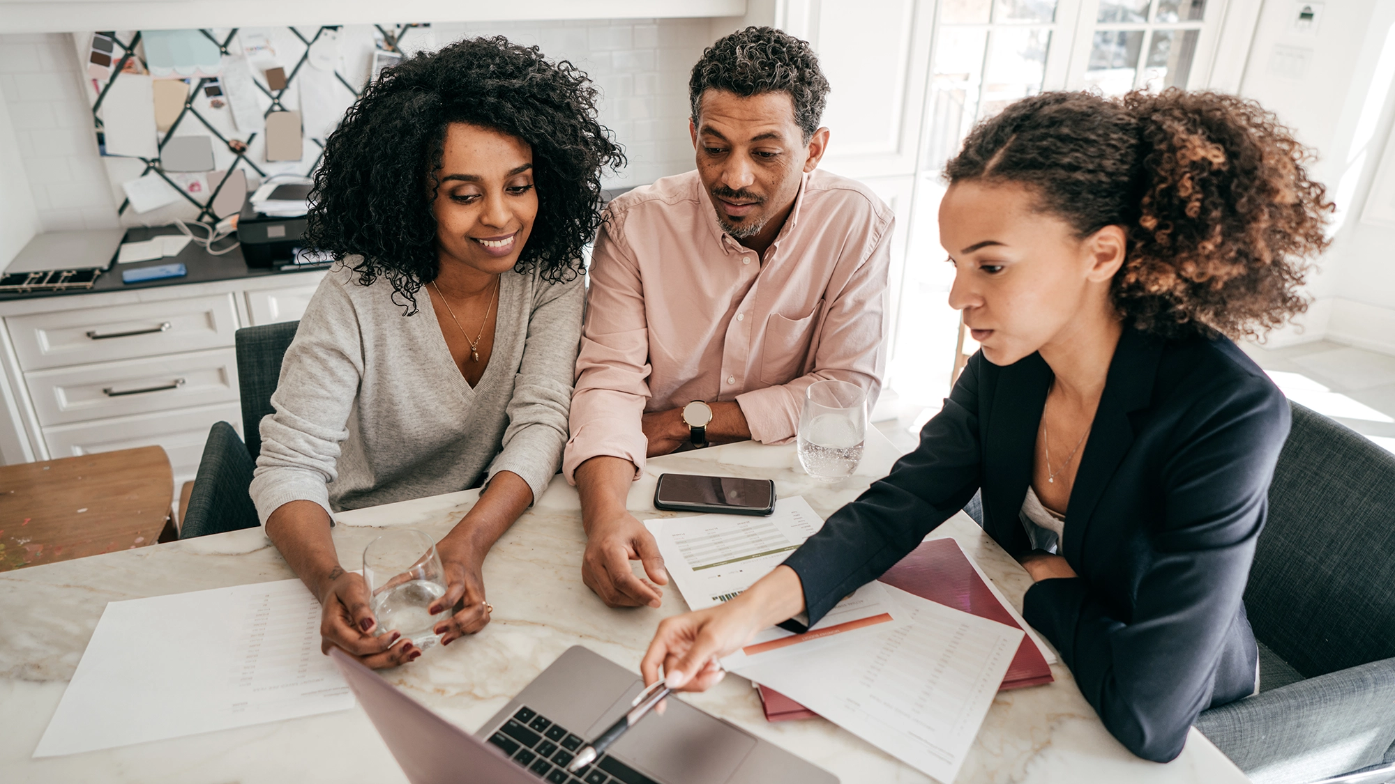 An accountant explaining insurance options to a couple.